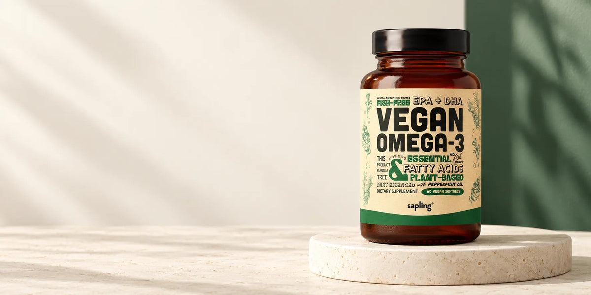 Sapling Vegan Omega-3 bottle on a stone plinth